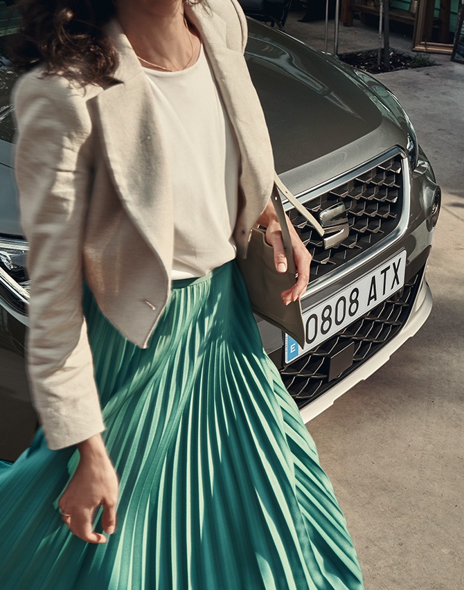 woman walking beside seat arona cliff grey colour