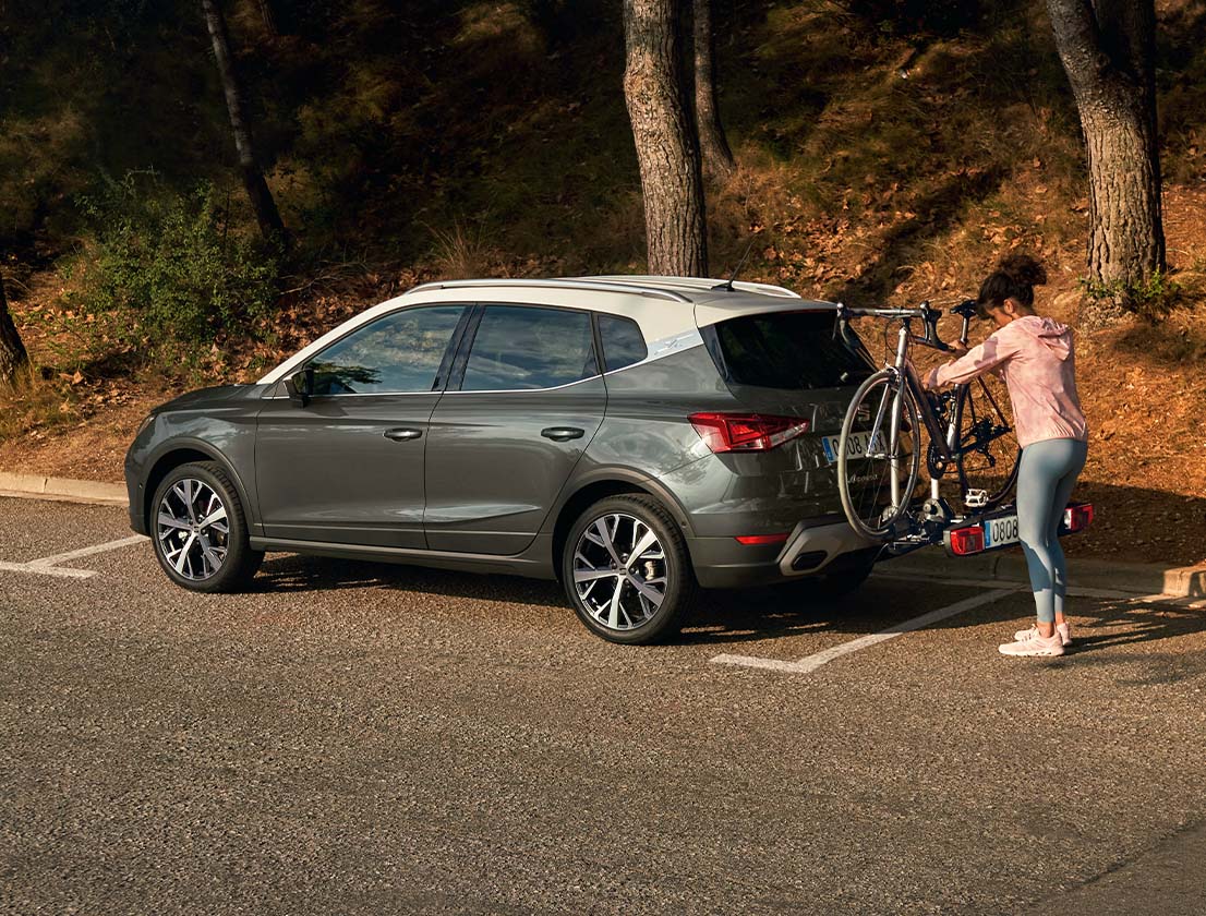 woman removing bike from bike rack seat arona