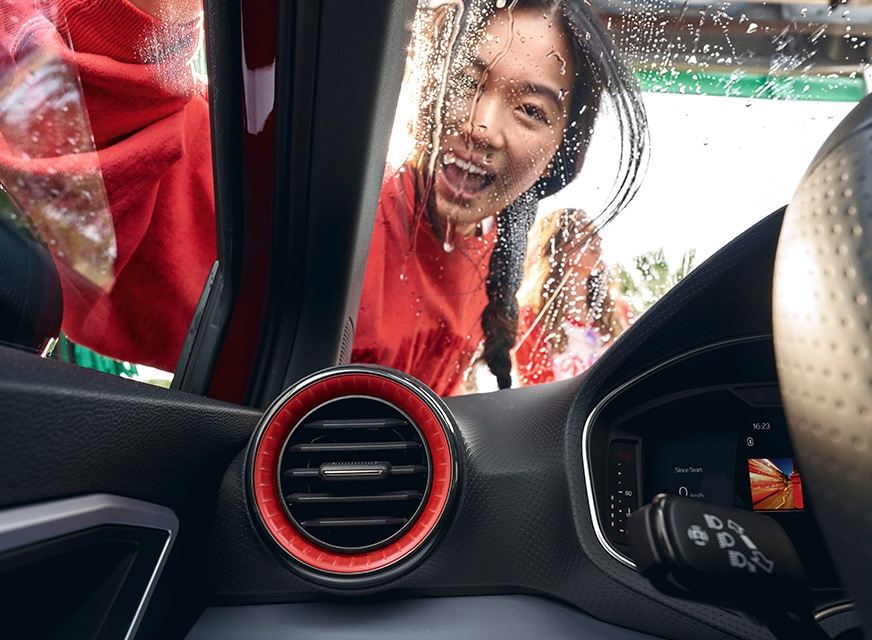 seat ibiza interior view woman cleaning windshield