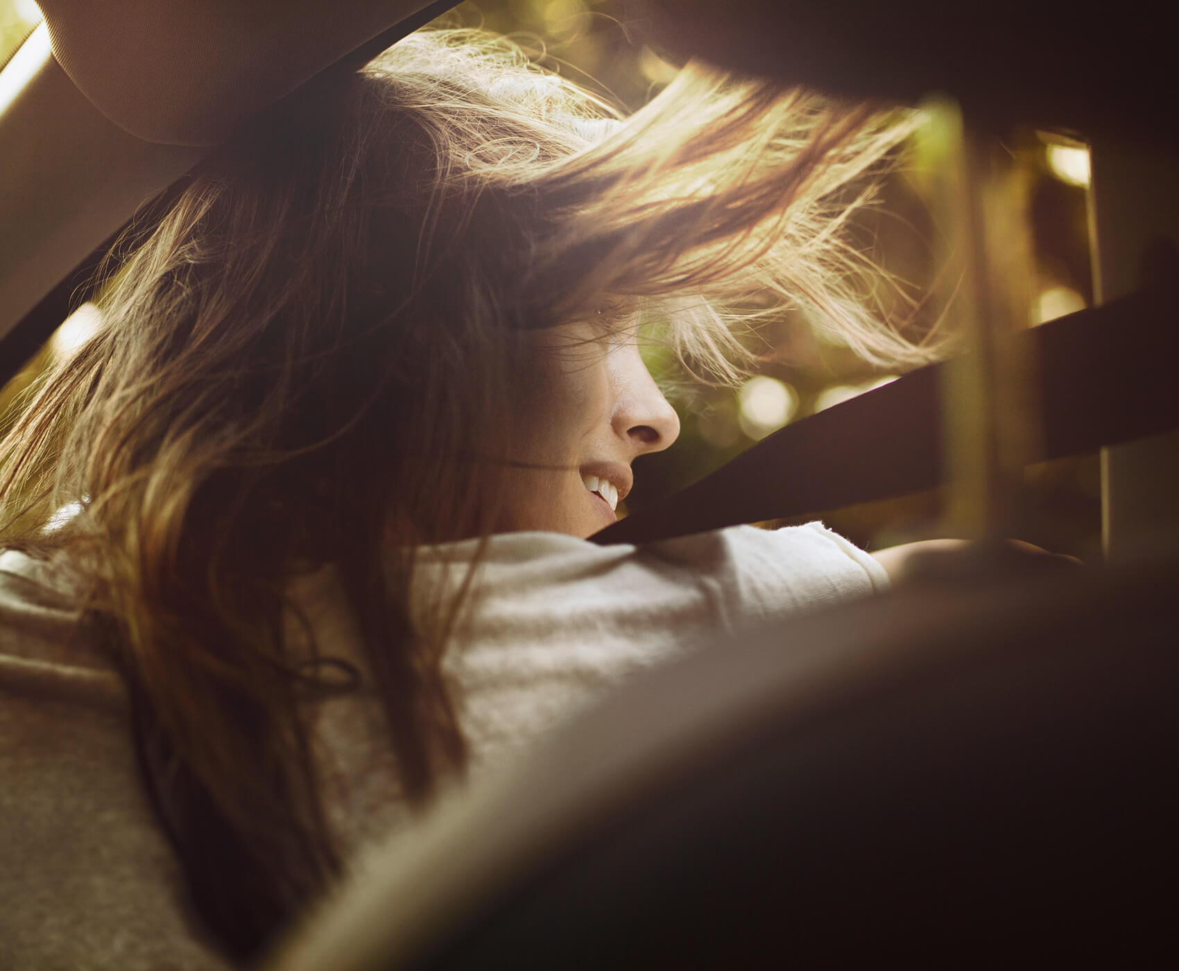 Rear view image of a woman's face with her hair blowing in the wind - SEAT Easy Mobility
