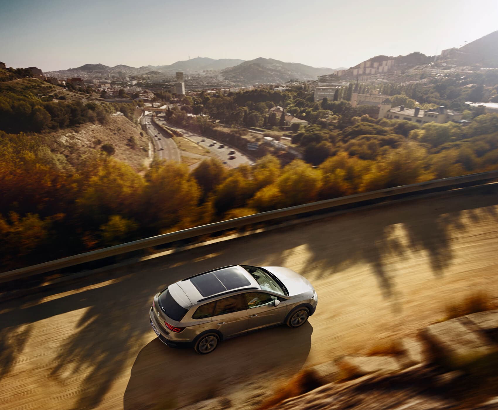 SEAT new car services and maintenance – arial view of a SEAT Leon Sportstourer driving in the countryside