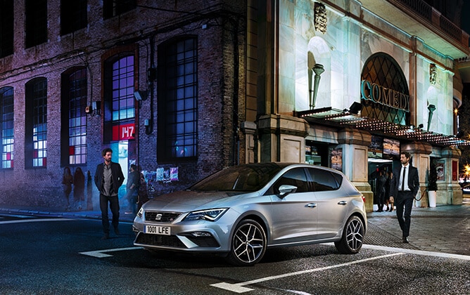 SEAT Leon parked outside in two urban and elegant scenes