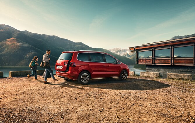 SEAT Alhambra in a mountain landscape with a man and little boy going to the car