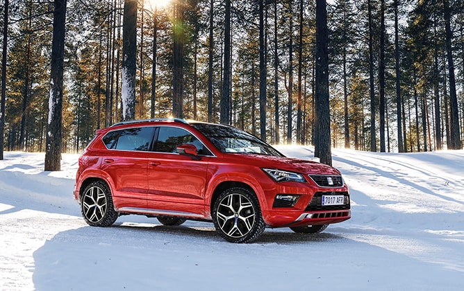 SEAT Ateca in a snowy winter landscape in the forest